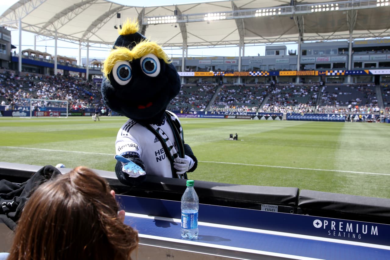 Mar 19, 2022; Carson, California, USA; Los Angeles Galaxy team mascot greets a fan before the game between the Los Angeles Galaxy and the Orlando City SC at Dignity Health Sports Park. Mandatory Credit: Kiyoshi Mio-USA TODAY Sports