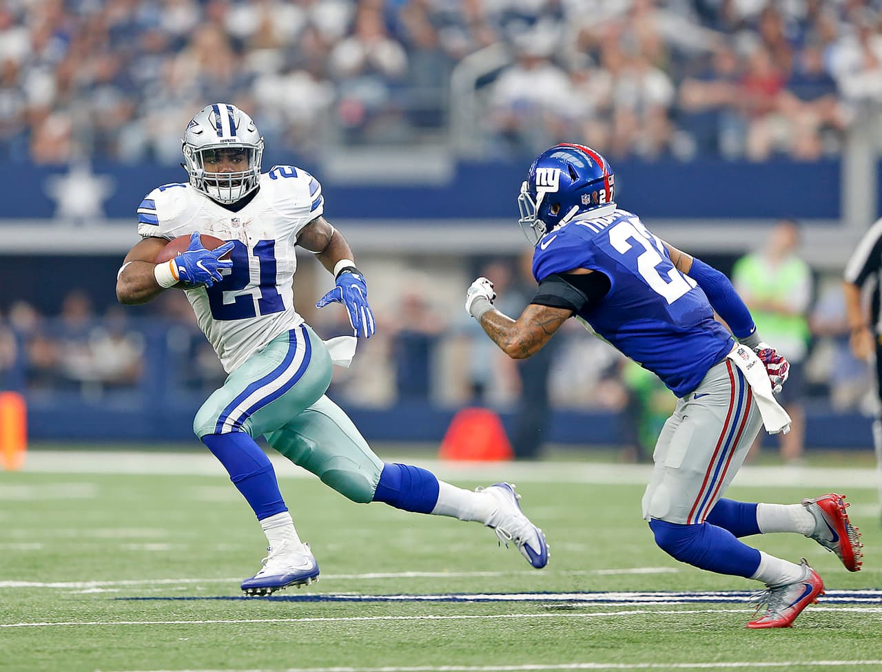 Dallas Cowboys running back Ezekiel Elliott (21) runs as New York Giants safety Darian Thompson (27) defends during the 2016 NFL week 1 regular season game, Sunday, Sept. 11, 2016, in Arlington, Texas. The Giants defeated the Cowboys, 20-19. (James D. Smith via AP)
