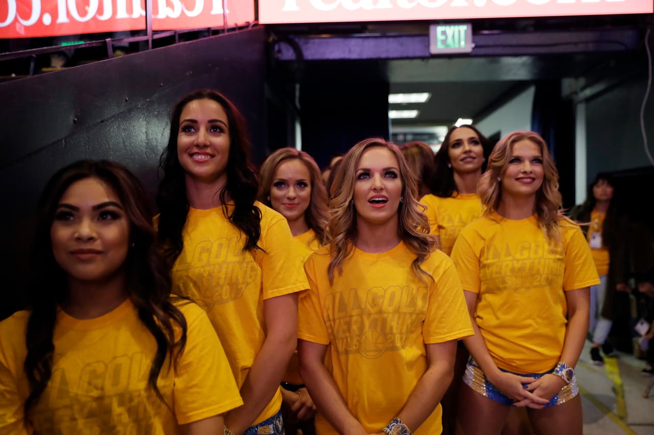Cheerleaders watch television coverage of Game 4 of basketball's NBA Finals between the Golden State Warriors and the Cleveland Cavaliers, Friday, June 9, 2017, at Oracle Arena in Oakland, Calif. (AP Photo/Marcio Jose Sanchez)