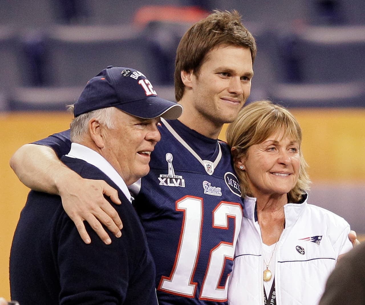 New England Patriots quarterback Tom Brady (12) poses for a photo with his parents, Tom and Galynn Brady, in Lucas Oil Stadium on Saturday, Feb. 4, 2012, in Indianapolis. The Patriots are scheduled to face the New York Giants in NFL football Super Bowl XLVI on Feb. 5. (AP Photo/Mark Humphrey)