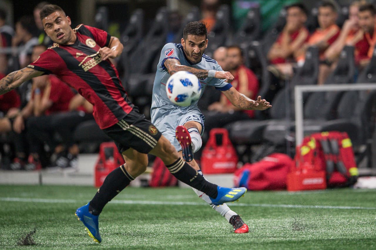 Jun 20, 2018; Atlanta, GA, USA; Chicago Fire defender Jorge Luis Corrales (25) kicks the ball past Atlanta United forward Hector Villalba (15) during the first half at Mercedes-Benz Stadium. Mandatory Credit: Dale Zanine-USA TODAY Sports