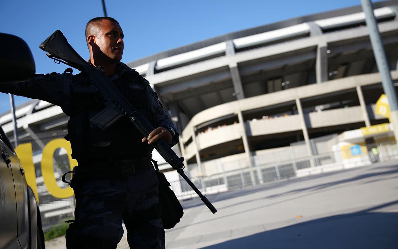 RIO DE JANEIRO, BRAZIL - MAY 04: A military police officer keeps watch before a match between Flamengo and Palmeiras as part of Brasileirao Series A 2014 at Maracana Stadium on May 04, 2014 in Rio de Janeiro, Brazil. The legendary stadium was constructed in the heart of Rio de Janeiro ahead of the 1950 FIFA World Cup and at one point seated at least 183,000 people. Considered the temple of Brazilian soccer, where legend Pele scored his 1,000th goal, the stadium received a $600-million makeover for the 2014 FIFA World Cup and will host the final match of the World Cup which starts June 12. (Photo by Mario Tama/Getty Images)