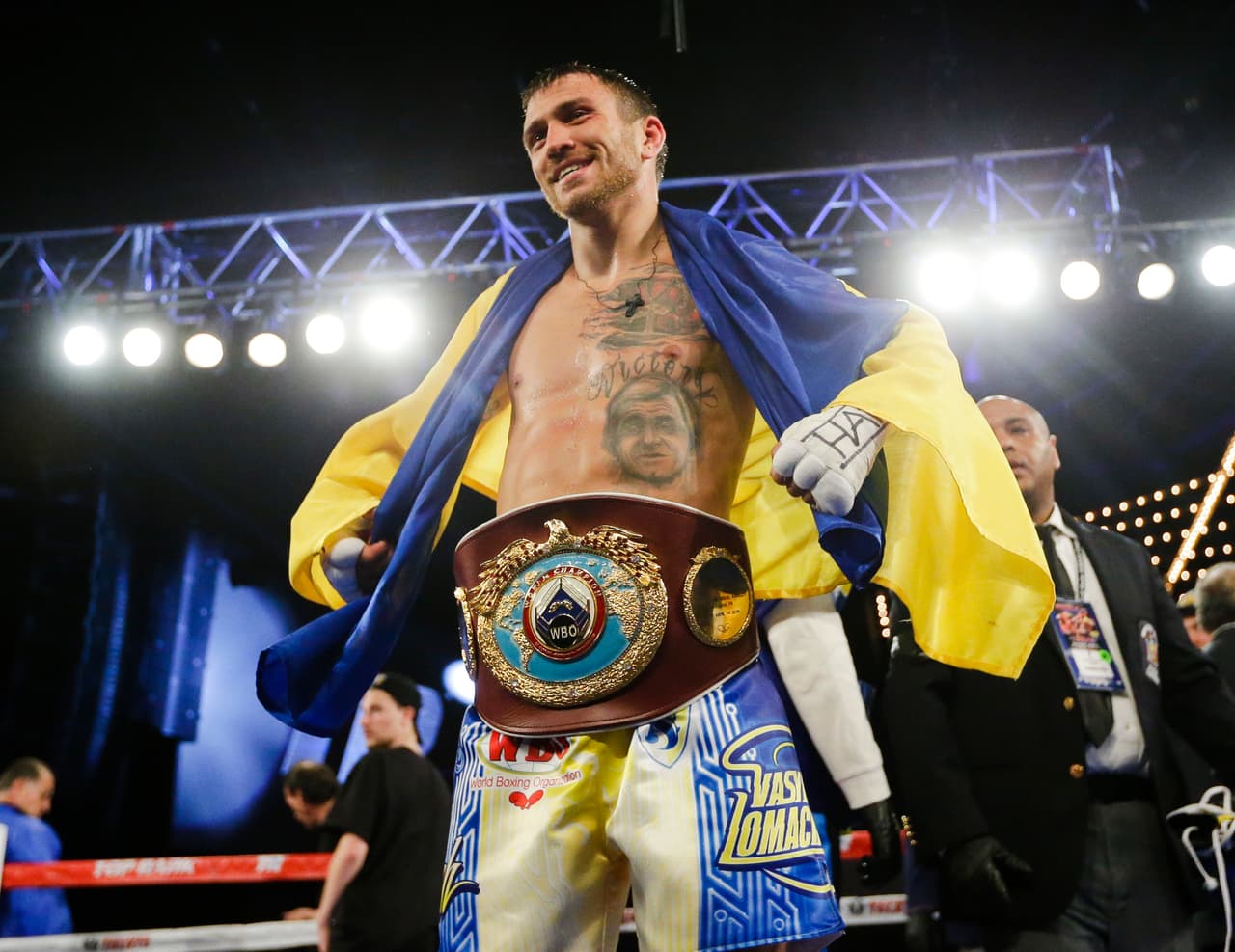 Vasyl Lomachenko, of Ukraine, poses for photographs with the WBO junior lightweight belt after a boxing match against Roman Martinez, of Puerto Rico, Saturday, June 11, 2016, in New York. Lomachenko stopped Martinez in the fifth round.(AP Photo/Frank Franklin II)