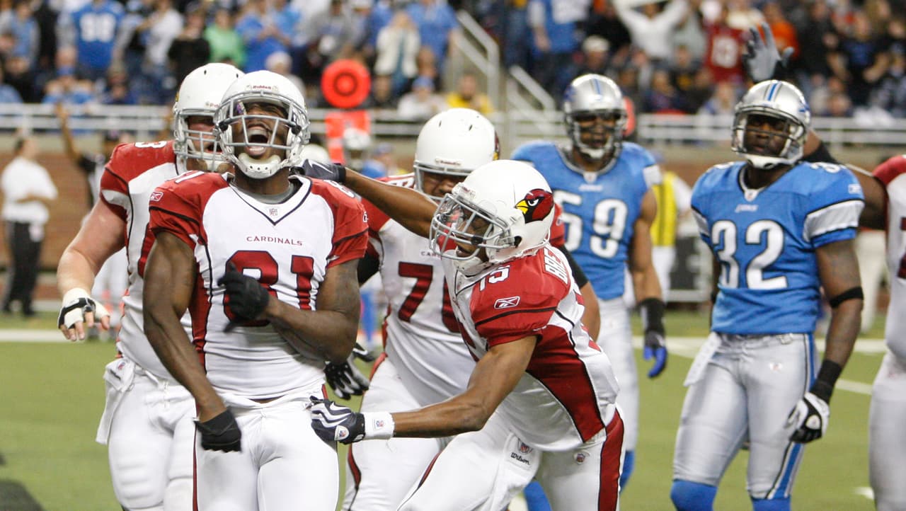 Arizona Cardinals wide receiver Anquan Boldin, second from left, is congratulted by teammates after scoring a touchdown to defeat the Detroit Lions in the closing minutes during an NFL football game at Ford Field in Detroit, Sunday, Dec. 20, 2009. (AP Photo/Carlos Osorio)