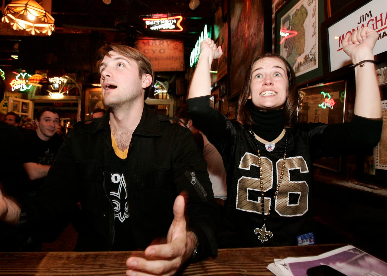 New Orleans Saints fans Chester Rockwell and Jennifer Flynn, of New Orleans, react in Molly's at the Market bar in the French Quarter after an interception by New Orleans Saints linebacker Scott Fujita against the Minnesota Vikings in the first half of an NFC Championship NFL football game in New Orleans, Sunday, Jan. 24, 2010. (AP Photo/Patrick Semansky)