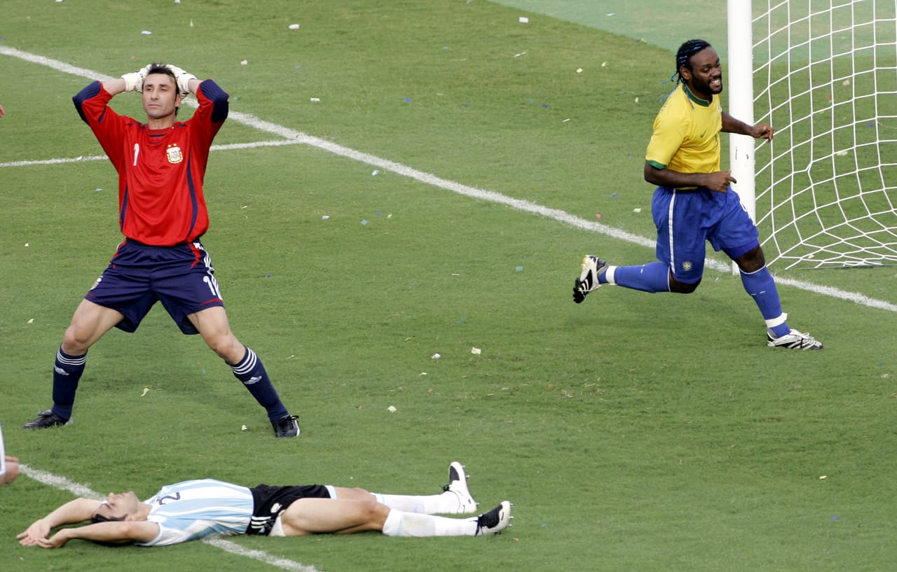Brazil's Vanger Love, right, celebrates as Argentina's Roberto Abbondanzieri, reacts, after Roberto Ayala's, on the ground, secored an own goal to put Brazil ahead 2-0, during the final of the Copa America in Maracaibo, Venezuela, Sunday, July 15, 2007.(AP Photo/Fernando Vergara)
