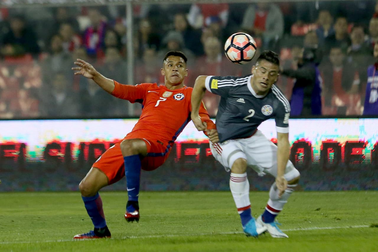 Chile's Alexis Sanchez, left, and Paraguay's Jorge Moreira vie for the ball during a 2018 World Cup qualifying soccer match in Santiago, Chile, Thursday, Aug. 31, 2017. (AP Photo/Esteban Felix)