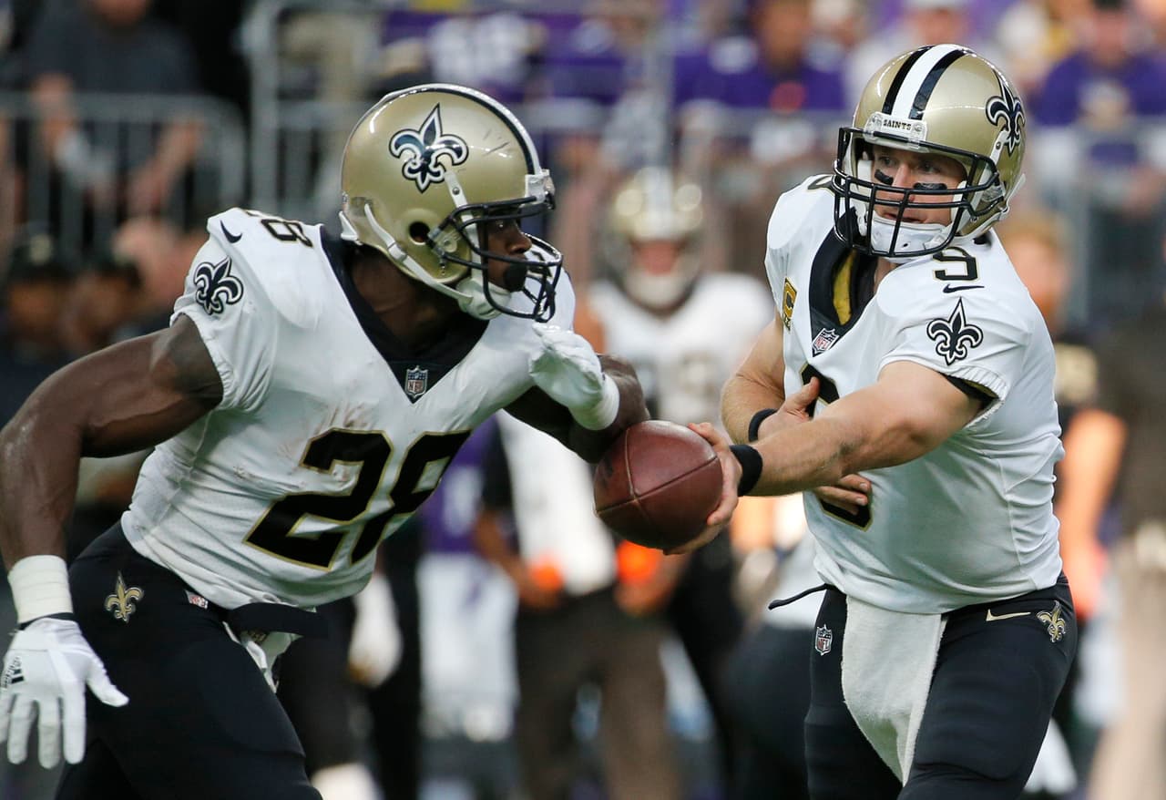 New Orleans Saints quarterback Drew Brees (9) hands the ball off to running back Adrian Peterson during the first half of an NFL football game against the Minnesota Vikings, Monday, Sept. 11, 2017, in Minneapolis. (AP Photo/Bruce Kluckhohn)