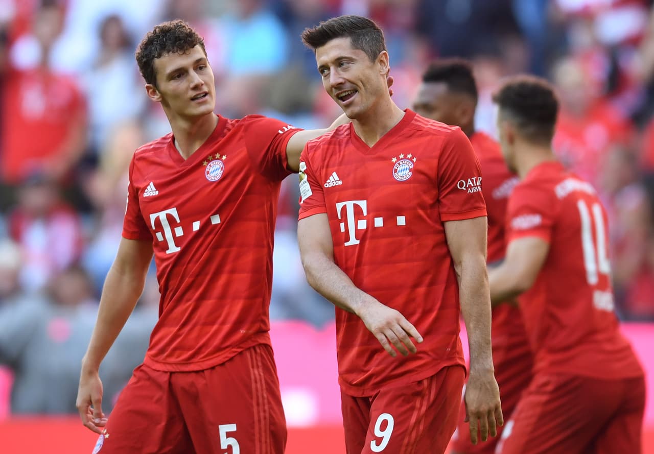 Bayern Munich's French defender Benjamin Pavard (L) and Bayern Munich's Polish striker Robert Lewandowski (R) react after the second goal for Munich during the German first division Bundesliga football match FC Bayern Munich vs 1. FC Cologne in Munich on September 21, 2019. (Photo by Christof STACHE / AFP) (Photo credit should read CHRISTOF STACHE/AFP/Getty Images)