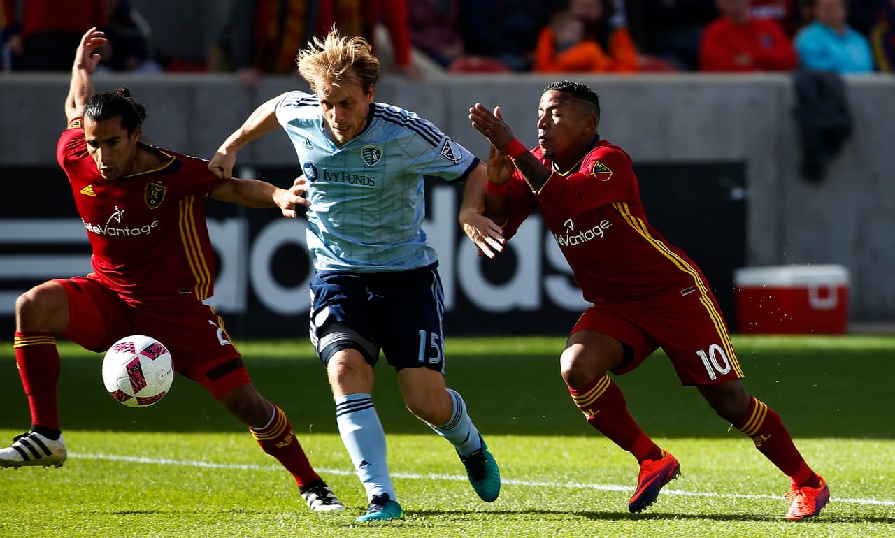 Oct 16, 2016; Sandy, UT, USA; Real Salt Lake defender Tony Beltran (2) and forward Joao Plata (10) battle for the ball against Sporting Kansas City defender Seth Sinovic (15) in the first half at Rio Tinto Stadium. Mandatory Credit: Jeff Swinger-USA TODAY Sports