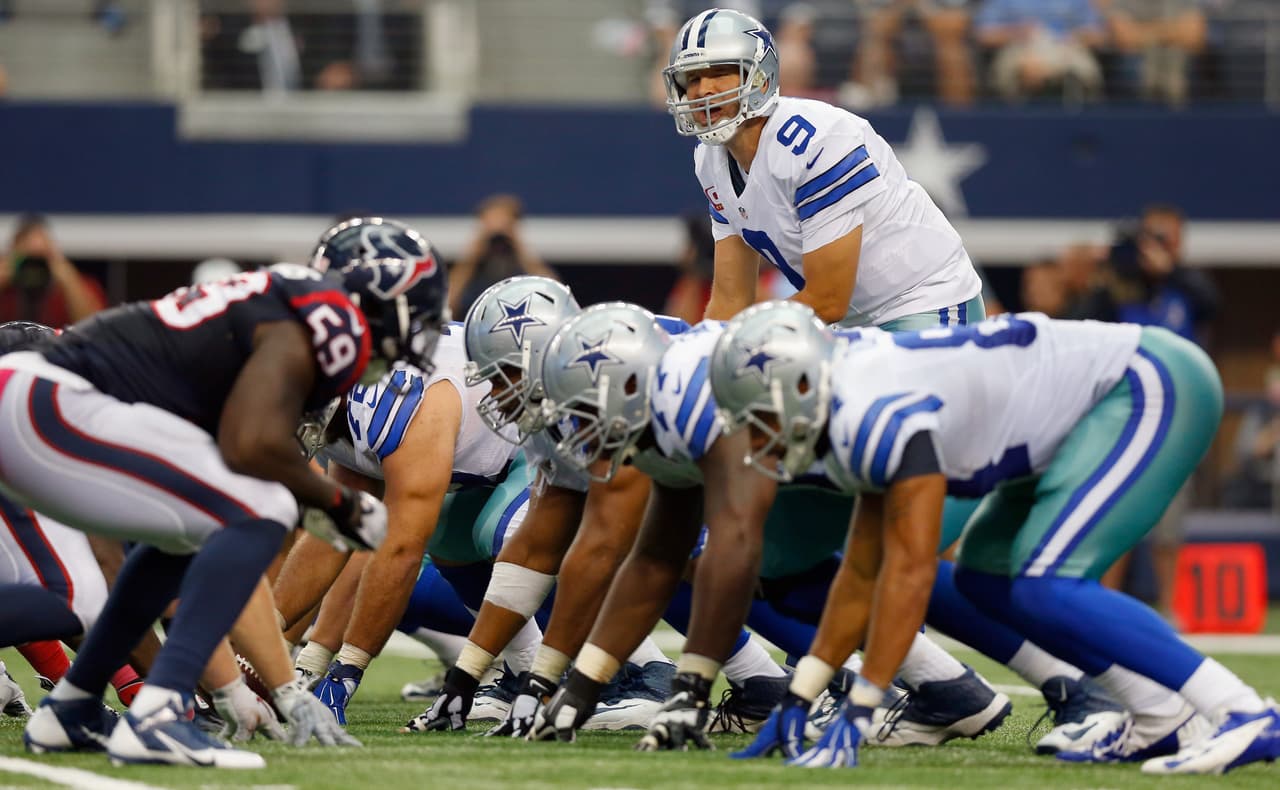 ARLINGTON, TX - OCTOBER 05: Tony Romo #9 of the Dallas Cowboys leads the Cowboys against the Houston Texans in the secodn half at AT&T Stadium on October 5, 2014 in Arlington, Texas. (Photo by Tom Pennington/Getty Images)