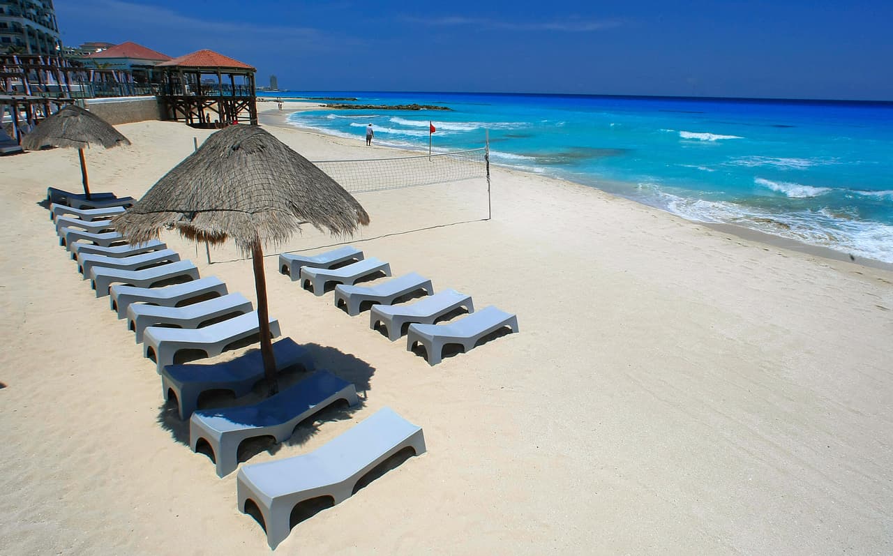 TO GO WITH AFP STORY Photograph taken May 12, 2009 in Cancun, Mexico of empty lying chairs in Cancun Beach. Hotel occupancy has sunk across the country due to the crisis, and 25 hotels have temporarily closed in and around Cancun, local officials said Monday. Hotels in the area offered free vacations for three years to any tourist catching swine flu while on holiday there in a bid to counter the blow to the industry. AFP PHOTO/Luis Acosta (Photo credit should read LUIS ACOSTA/AFP/Getty Images)