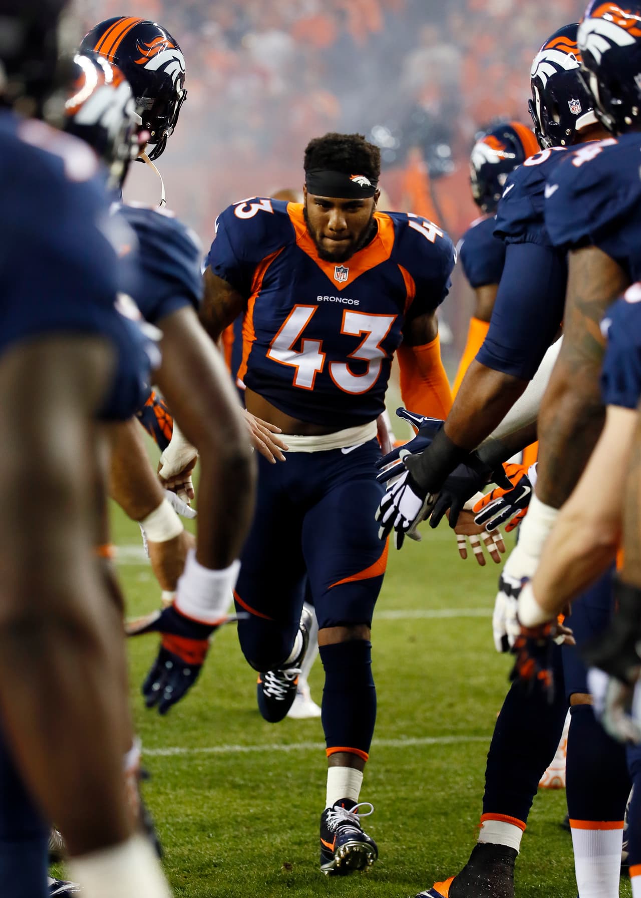 Denver Broncos strong safety T.J. Ward runs onto the field during an NFL football game between the Denver Broncos and the San Francisco 49ers, Sunday, Oct. 19, 2014, in Denver. (AP Photo/Jack Dempsey)