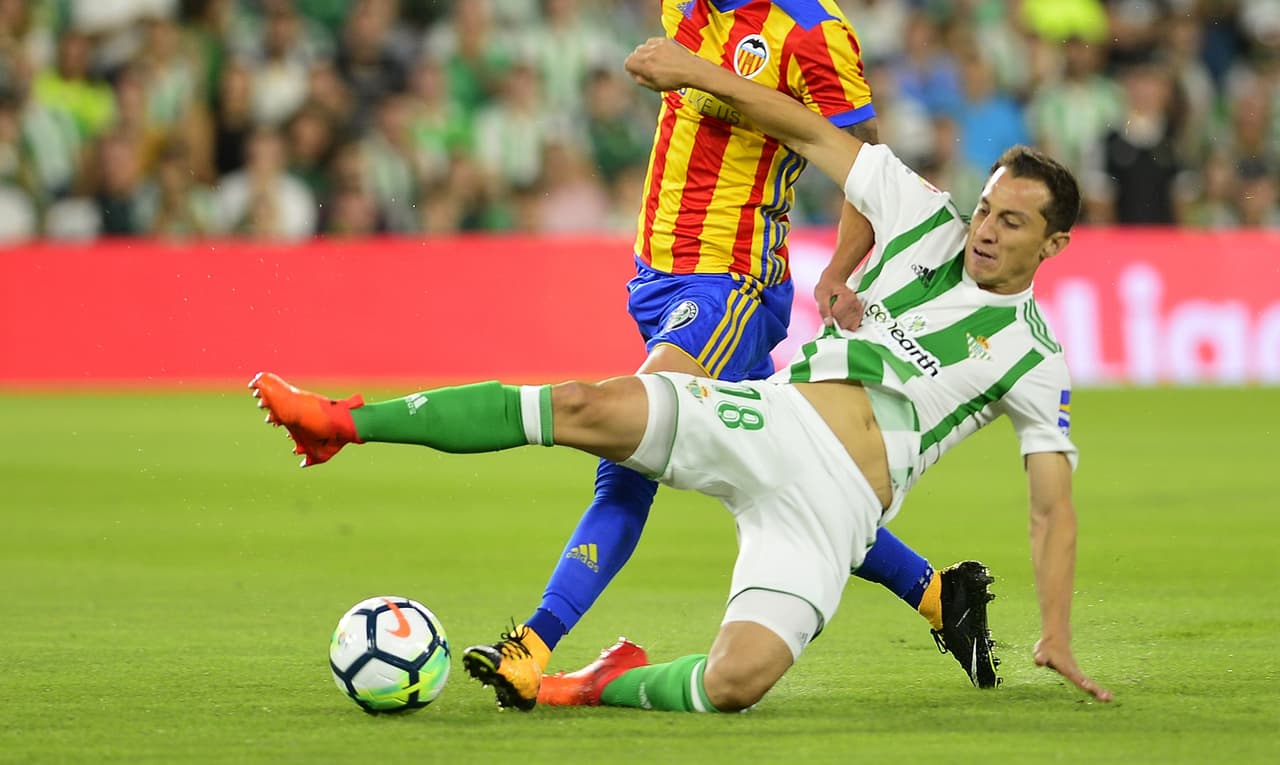 Valencia's Spanish forward Rodri (up) fights for the ball with Real Betis' Mexican midfielder Andres Guardado (down) during the Spanish league football match Real Betis FC vs Valencia FC at the Benito Villamarin stadium in Sevilla on October 15, 2017. / AFP PHOTO / CRISTINA QUICLER (Photo credit should read CRISTINA QUICLER/AFP/Getty Images)