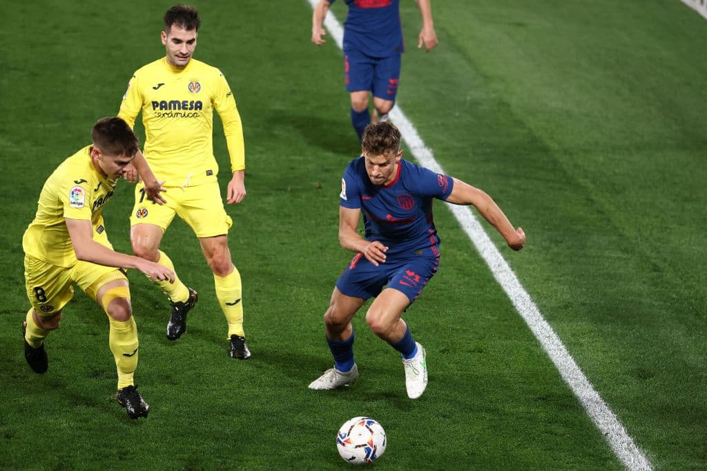 Atletico Madrid's Spanish midfielder Marcos Llorente (R) runs for the ball during the Spanish league football match between Villarreal CF and Club Atletico de Madrid at La Ceramica stadium in Vila-real on February 28, 2021. (Photo by JOSE JORDAN / AFP) (Photo by JOSE JORDAN/AFP via Getty Images)