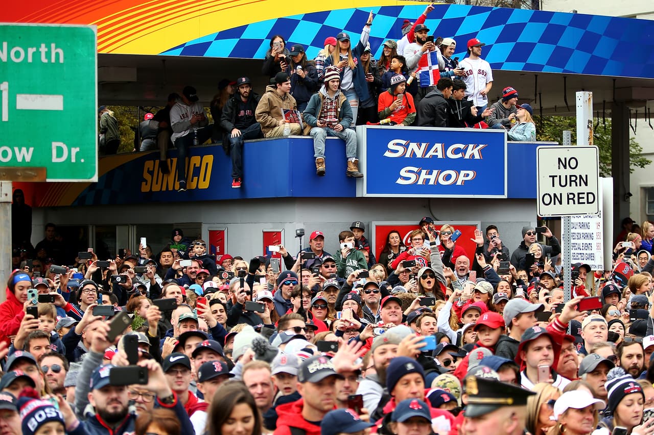 BOSTON, MA - OCTOBER 31: Fans gather at a Sunoco gas station outside of Fenway Park to see the 2018 Boston Red Sox World Series victory parade on October 31, 2018 in Boston, Massachusetts. (Photo by Adam Glanzman/Getty Images)
