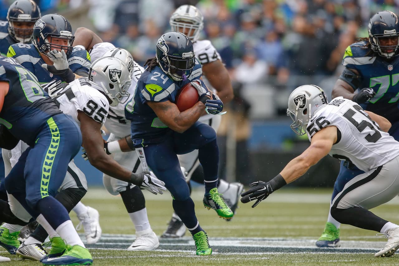 SEATTLE, WA - NOVEMBER 02: Running back Marshawn Lynch #24 of the Seattle Seahawks rushes against the Oakland Raiders at CenturyLink Field on November 2, 2014 in Seattle, Washington. (Photo by Otto Greule Jr/Getty Images)