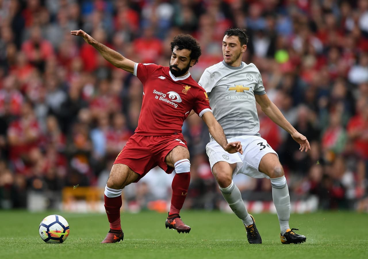 LIVERPOOL, ENGLAND - OCTOBER 14: Mohamed Salah of Liverpool and Matteo Darmian of Manchester United battle for possession during the Premier League match between Liverpool and Manchester United at Anfield on October 14, 2017 in Liverpool, England. (Photo by Shaun Botterill/Getty Images)