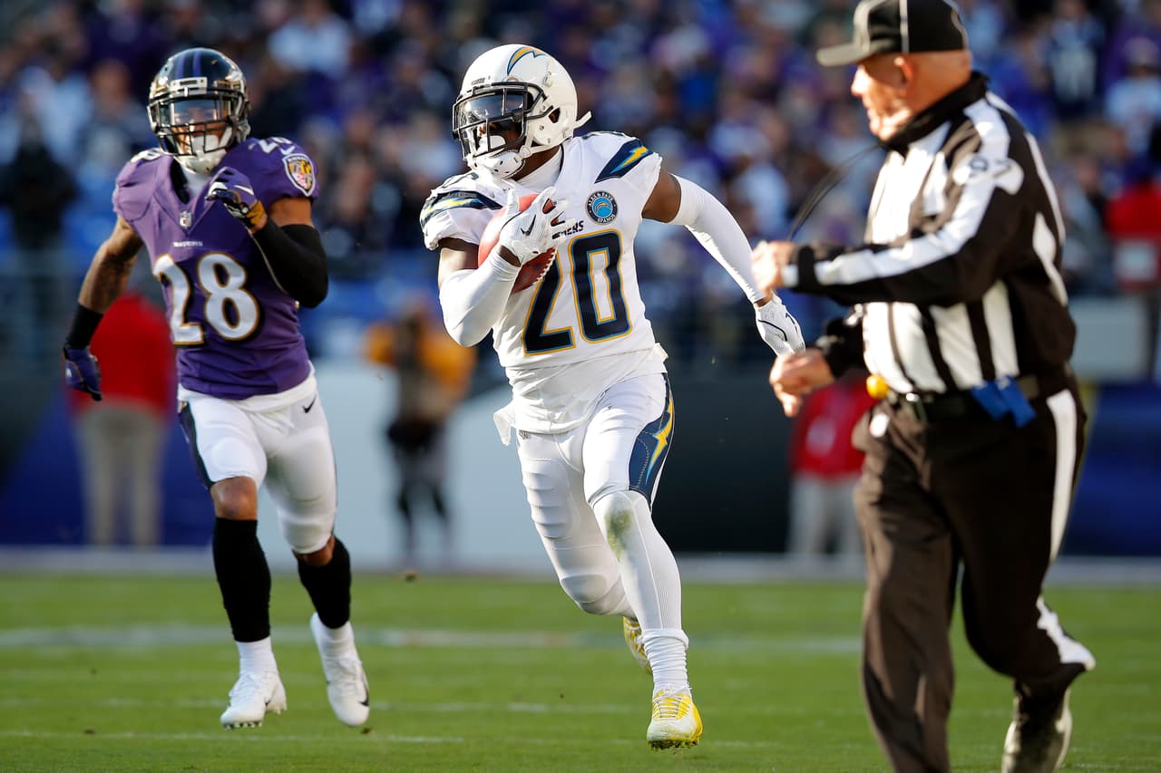 Los Angeles Chargers defensive back Desmond King (20) rushes the ball past Baltimore Ravens cornerback Anthony Averett in the second half of an NFL wild card playoff football game, Sunday, Jan. 6, 2019, in Baltimore. (AP Photo/Carolyn Kaster)