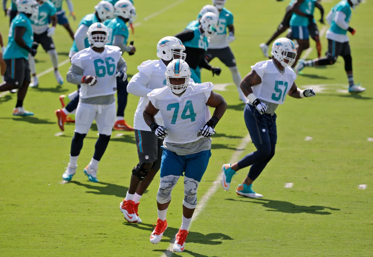 Miami Dolphins guard Jermon Bushrod (74) runs drills during the NFL football teams minicamp, Wednesday, June 15, 2016, at the Dolphins training facility in Davie, Fla. (AP Photo/Wilfredo Lee)