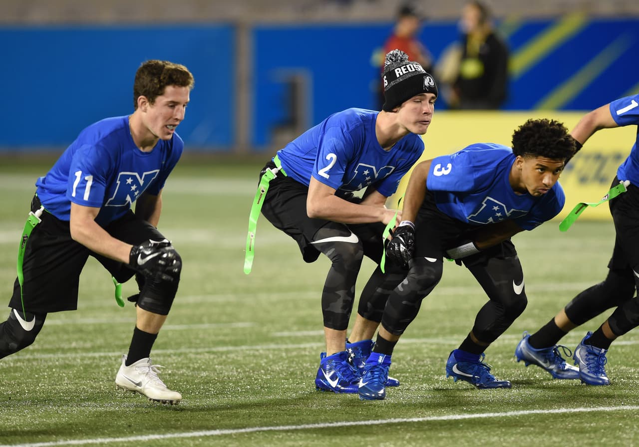 Virginia Extreme Redskins quarterback Brett Johnson (2) takes a snap from center Will Paige (3) during the 13-14 boys NFL flag football championship game Jan. 29, 2017 at the Pro Bowl in Orlando. (Al Messerschmidt via AP)