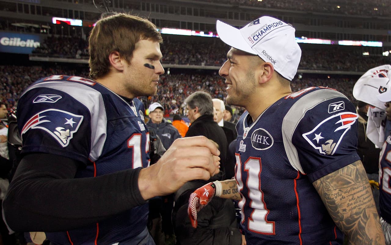 New England Patriots quarterback Tom Brady, left, congratulates Aaron Hernandez after their AFC Championship NFL football game against the Baltimore Ravens Sunday, Jan. 22, 2012, in Foxborough, Mass. The Patriots defeated the Ravens 23-20 to win the AFC Championship. (AP Photo/Charles Krupa)
