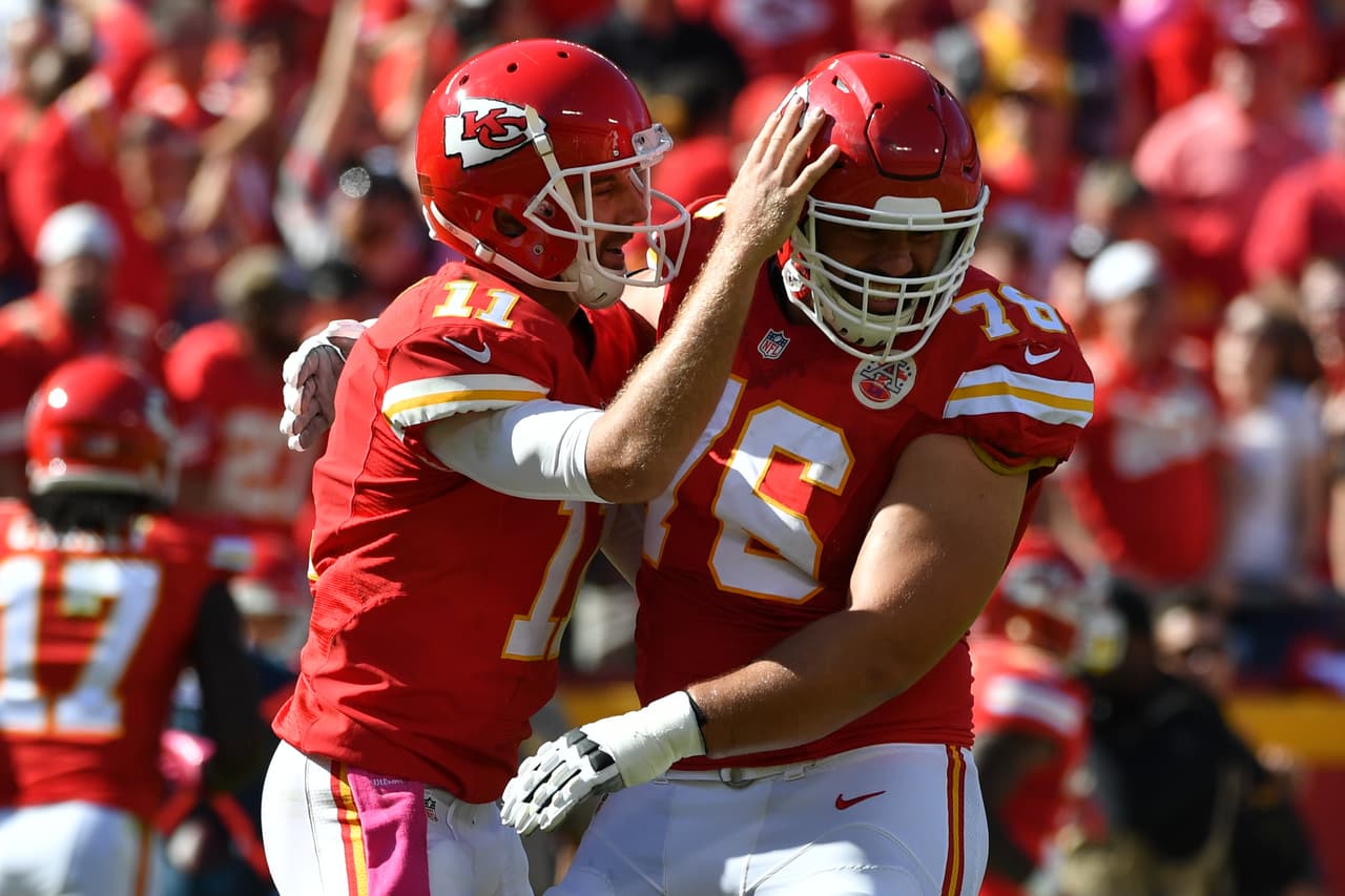 KANSAS CITY, MO - OCTOBER 23: Quarterback Alex Smith #11 of the Kansas City Chiefs celebrates a touchdown pass with Laurent Duvernay-Tardif #76 at Arrowhead Stadium during the second quarter of the game against the New Orleans Saints on October 23, 2016 in Kansas City, Missouri. (Photo by Peter Aiken/Getty Images)