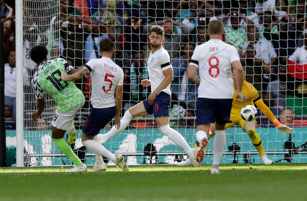 Nigeria's Alex Iwobi, left, scores his side's opening goal during a friendly soccer match between England and Nigeria at Wembley stadium in London, Saturday, June 2, 2018. (AP Photo/Matt Dunham)
