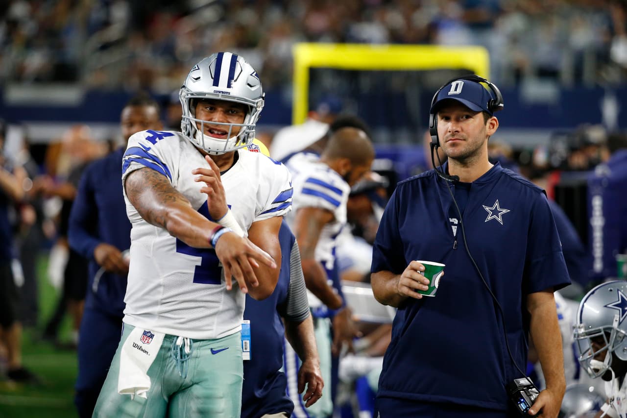 Dallas Cowboys quarterback Dak Prescott (4) throws a pass as he talks with quarterback Tony Romo, right, during an NFL football game against the Philadelphia Eagles on Sunday, Oct. 30, 2016, in Arlington, Texas. (AP Photo/Michael Ainsworth)