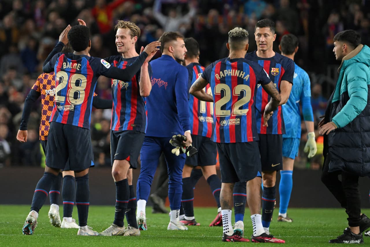 Barcelona's players celebrate at the end of the Spanish league football match between FC Barcelona and Real Madrid CF at the Camp Nou stadium in Barcelona on March 19, 2023. (Photo by LLUIS GENE / AFP) (Photo by LLUIS GENE/AFP via Getty Images)