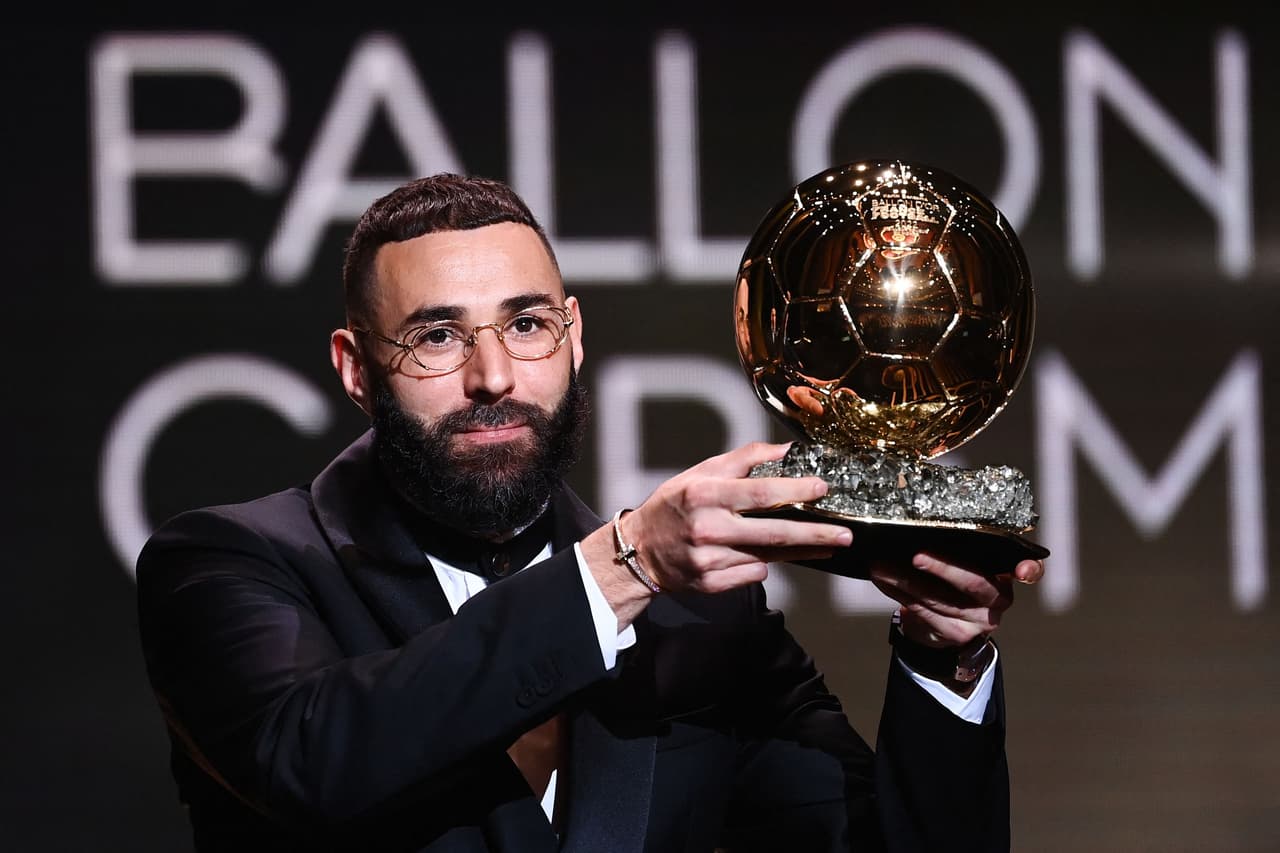 Real Madrid's French forward Karim Benzema receives the Ballon d'Or award during the 2022 Ballon d'Or France Football award ceremony at the Theatre du Chatelet in Paris on October 17, 2022. (Photo by FRANCK FIFE / AFP) (Photo by FRANCK FIFE/AFP via Getty Images)
