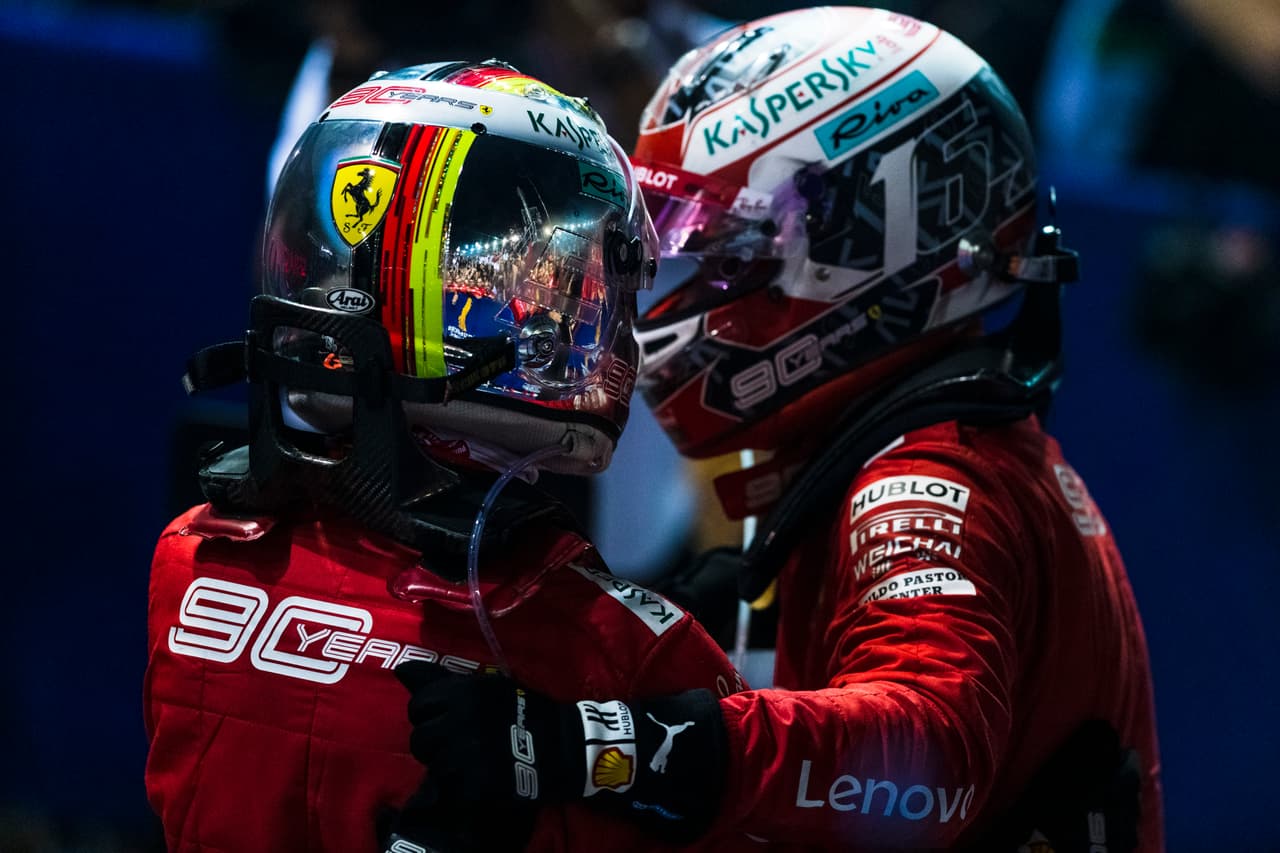 Los pilotos de Ferrari, Sebastian Vettel y Cherles Leclerc se saludan festejando al terminar la carrera del Grand Prix de Singapur.