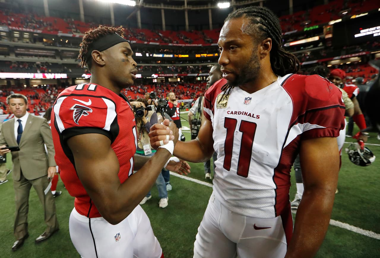 Atlanta Falcons wide receiver Julio Jones (11) speaks to Arizona Cardinals wide receiver Larry Fitzgerald (11) after an NFL football game, Sunday, Nov. 27, 2016, in Atlanta. The Falcons won 38-19. (AP Photo/John Bazemore)