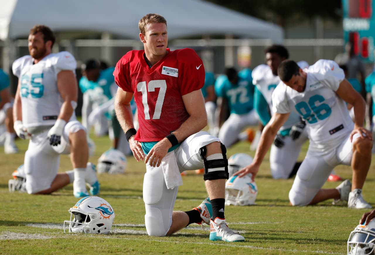 Miami Dolphins quarterback Ryan Tannehill stretches out during an NFL football training camp, Thursday, Aug. 3, 2017 at the Dolphins training facility in Davie, Fla. (AP Photo/Wilfredo Lee)