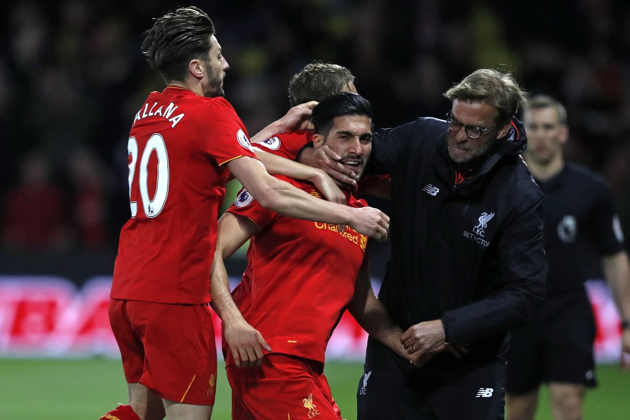 Liverpool's German midfielder Emre Can (C) celebrates with Liverpool's English midfielder Adam Lallana (L) and Liverpool's German manager Jurgen Klopp after scoring the opening goal of the English Premier League football match between Watford and Liverpool at Vicarage Road Stadium in Watford, north of London on May 1, 2017. / AFP PHOTO / Adrian DENNIS / RESTRICTED TO EDITORIAL USE. No use with unauthorized audio, video, data, fixture lists, club/league logos or 'live' services. Online in-match use limited to 75 images, no video emulation. No use in betting, games or single club/league/player publications. / (Photo credit should read ADRIAN DENNIS/AFP/Getty Images)