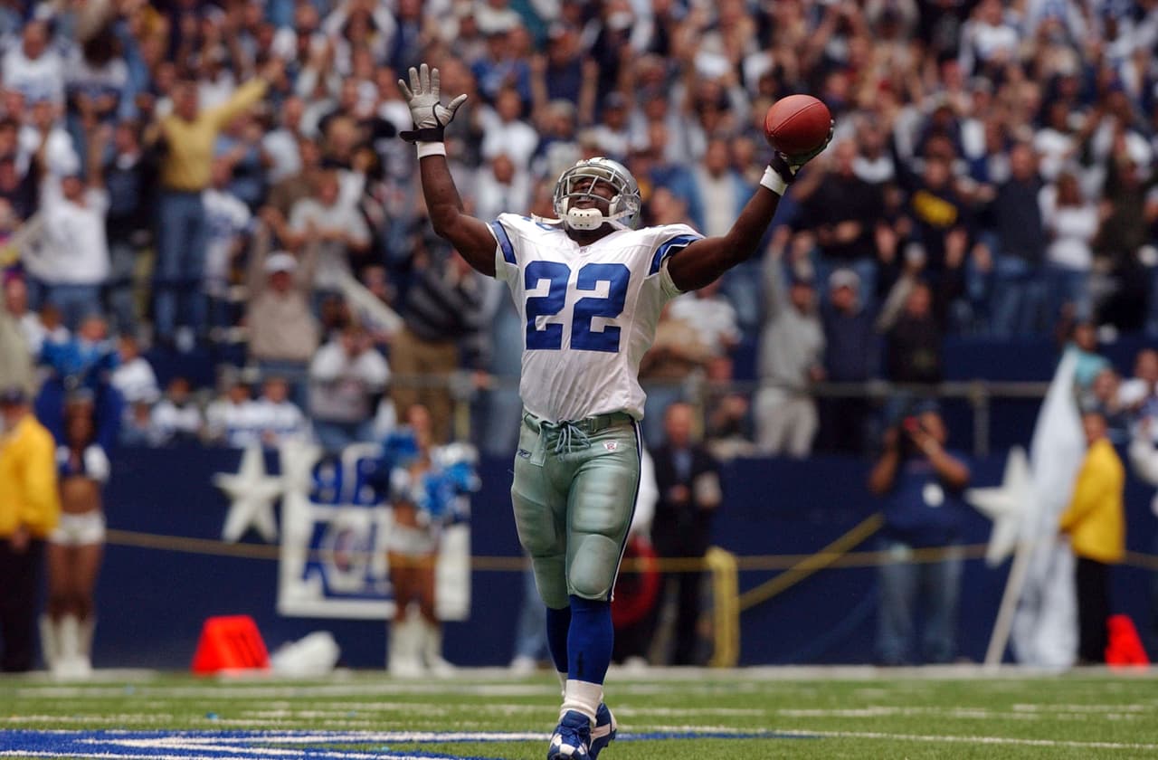Dallas Cowboys running back Emmitt Smith celebrates breaking the all-time rushing record in a game against the Seattle Seahawks in Irving, Texas, Sunday, Oct. 27. 2002. Smith became the NFL's career rushing with an 11-yard run in the fourth quarter. The run gave the 33-year-old Smith 16,728 career yards, passing Walter Payton's mark of 16,726 yards. (AP Photo/Tony Gutierrez)