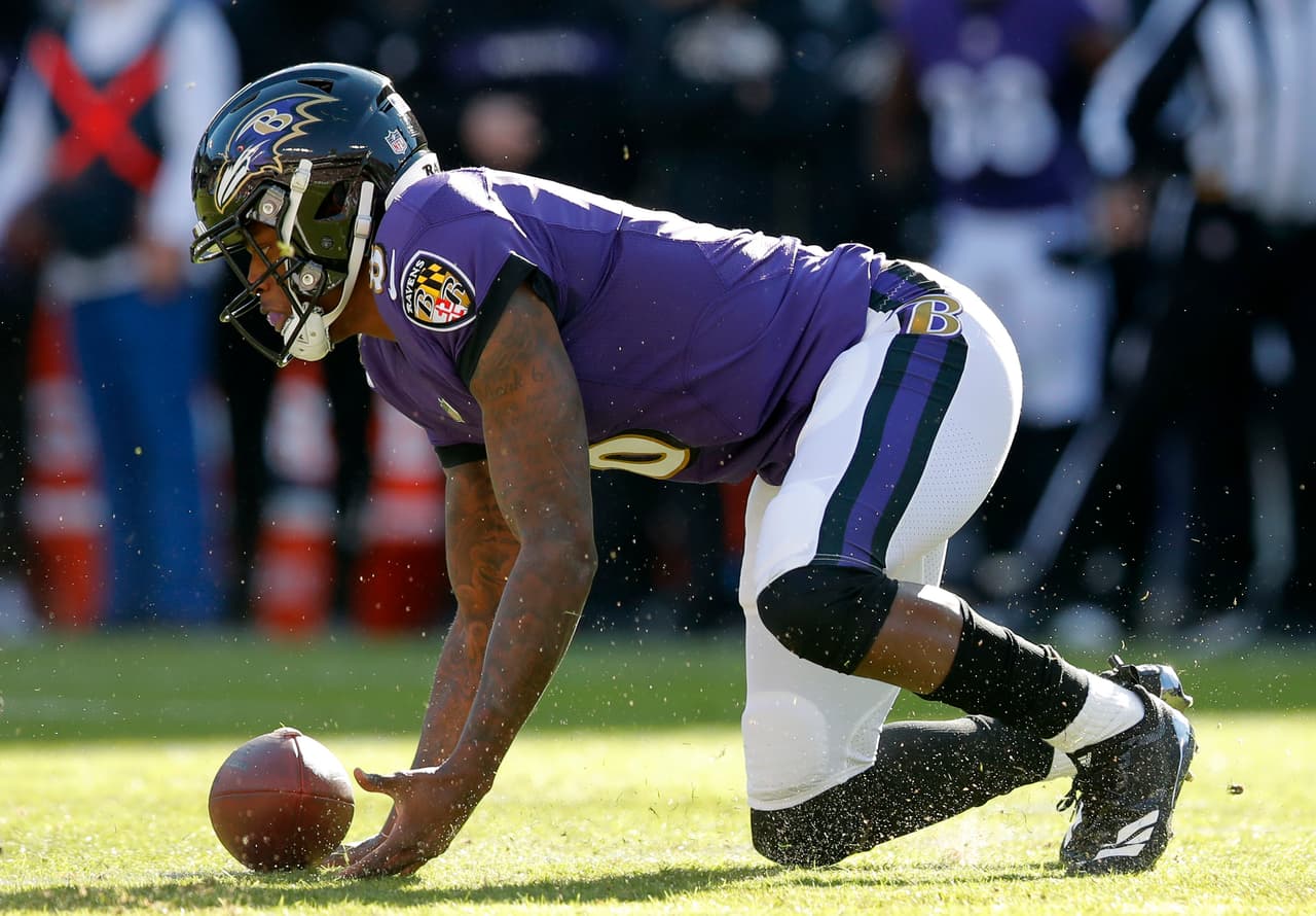 Baltimore Ravens quarterback Lamar Jackson recovers a fumble that he made in the first half of an NFL wild card playoff football game against the Los Angeles Chargers, Sunday, Jan. 6, 2019, in Baltimore. (AP Photo/Carolyn Kaster)