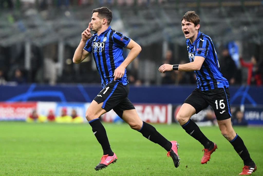 Atalanta's Swiss midfielder Remo Freuler (C) celebrates after scoring with Atalanta's Dutch midfielder Marten de Roon during the UEFA Champions League round of 16 first leg football match Atalanta Bergamo vs Valencia on February 19, 2020 at the San Siro stadium in Milan. (Photo by Vincenzo PINTO / AFP) (Photo by VINCENZO PINTO/AFP via Getty Images)