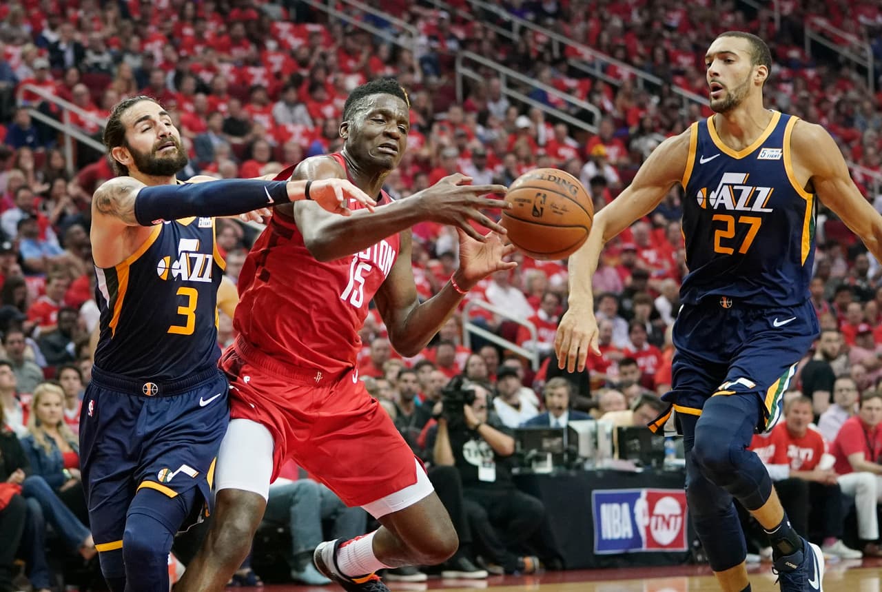 Houston Rockets center Clint Capela (15) loses the ball as he drives against Utah Jazz defenders Ricky Rubio (3) and Rudy Gobert (27) during the first half of Game 2 of a first-round NBA basketball playoff series in Houston, Wednesday, April 17, 2019. (AP Photo/David J. Phillip)