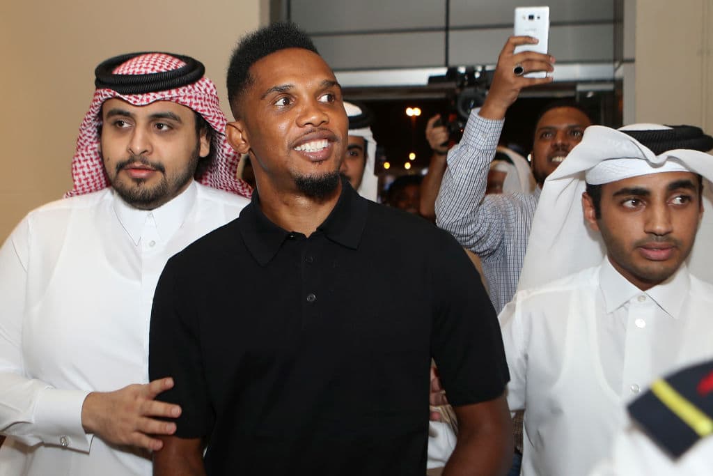 Cameroonian forward Samuel Eto'o arrives to attend a press conference after signing a one year contract to play for Qatar Sports Club football team next to the club's president Sheikh Jassim bin Hamad bin Nasser al-Thani (L), in Doha on August 14, 2018. - Veteran Cameroon star Samuel Eto'o has signed for Qatar league side, Qatar Sports Club, it was announced August 14, just days after he ended a brief stay at Turkish side Konyaspor. (Photo by KARIM JAAFAR / AFP) (Photo credit should read KARIM JAAFAR/AFP via Getty Images)