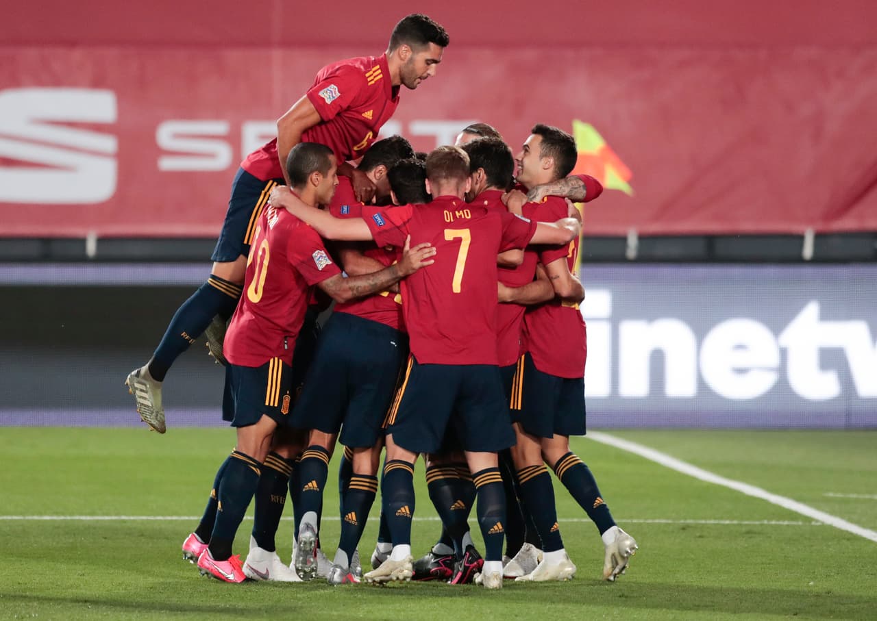 Spain's Sergio Ramos, obscured, is congratulated by teammates after scoring his team's first goal from the penalty spot during the UEFA Nations League soccer match between Spain and Ukraine at the Estadio Alfredo Di Stefano stadium in Madrid, Spain, Sunday, Sept. 6, 2020. (AP Photo/Bernat Armangue)