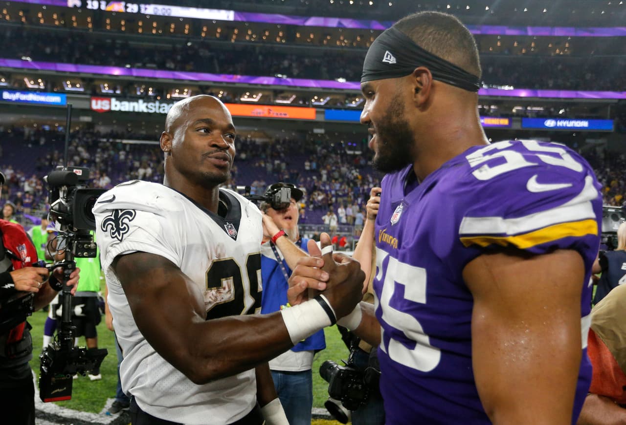 New Orleans Saints running back Adrian Peterson, left, talks with Minnesota Vikings outside linebacker Anthony Barr, right, after an NFL football game, Monday, Sept. 11, 2017, in Minneapolis. The Vikings won 29-19. (AP Photo/Bruce Kluckhohn)