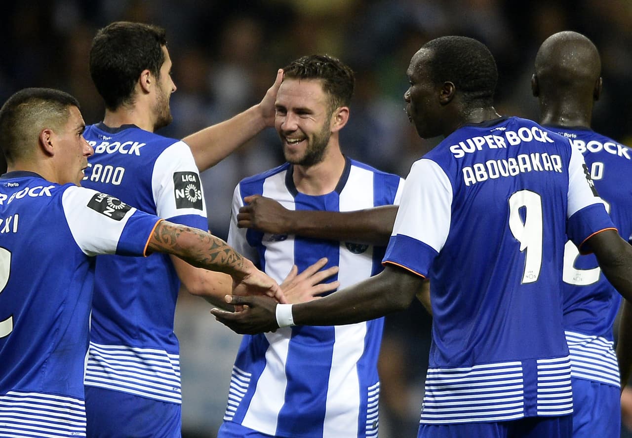 Porto's Mexican defender Miguel Layun (C) is congratulated by teammates after scoring a goal during the Portuguese league football match FC Porto vs Vitoria Setubal FC at the Dragao stadium in Porto on November 8, 2015. Porto won the match 2-0. AFP PHOTO/ MIGUEL RIOPA (Photo credit should read MIGUEL RIOPA/AFP/Getty Images)