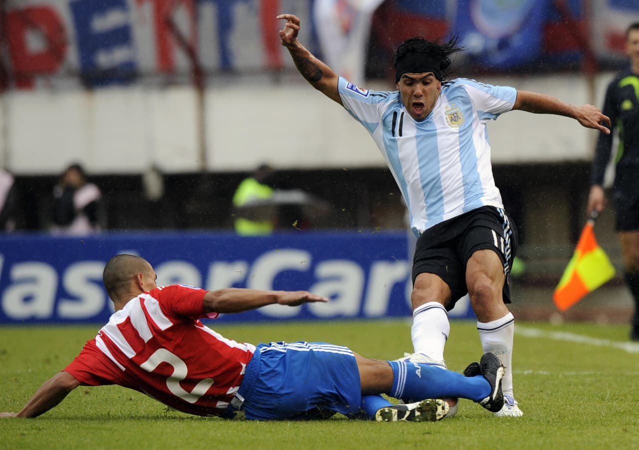 Argentina's Carlos Tevez (R) kicks Paraguay's Dario Veron during their FIFA World Cup South Africa 2010 qualifier football match at the Monumental stadium in Buenos Aires on September 6, 2008. Tevez receives a red card. AFP PHOTO / DANIEL GARCIA (Photo credit should read DANIEL GARCIA/AFP/Getty Images)