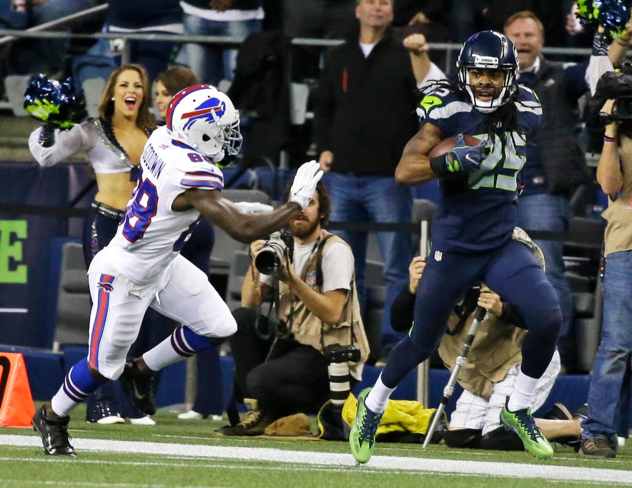 Seattle Seahawks cornerback Richard Sherman (25) runs past Buffalo Bills wide receiver Marquise Goodwin (88) after Sherman intercepted a pass in the second half of an NFL football game, Monday, Nov. 7, 2016, in Seattle. (AP Photo/Elaine Thompson)