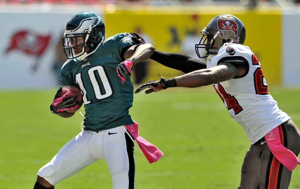 Philadelphia Eagles wide receiver DeSean Jackson (10) is shoved out of bounds by Tampa Bay Buccaneers cornerback Darrelle Revis (24) during the second quarter of an NFL football game Sunday, Oct. 13, 2013, in Tampa, Fla. (AP Photo/)