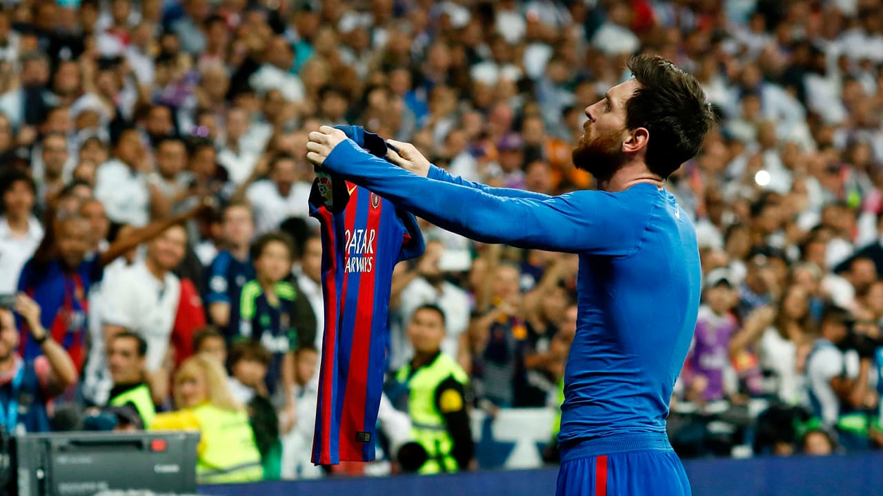 Barcelona's Argentinian forward Lionel Messi celebrates after scoring during the Spanish league Clasico football match Real Madrid CF vs FC Barcelona at the Santiago Bernabeu stadium in Madrid on April 23, 2017. / AFP PHOTO / OSCAR DEL POZO (Photo credit should read OSCAR DEL POZO/AFP/Getty Images)