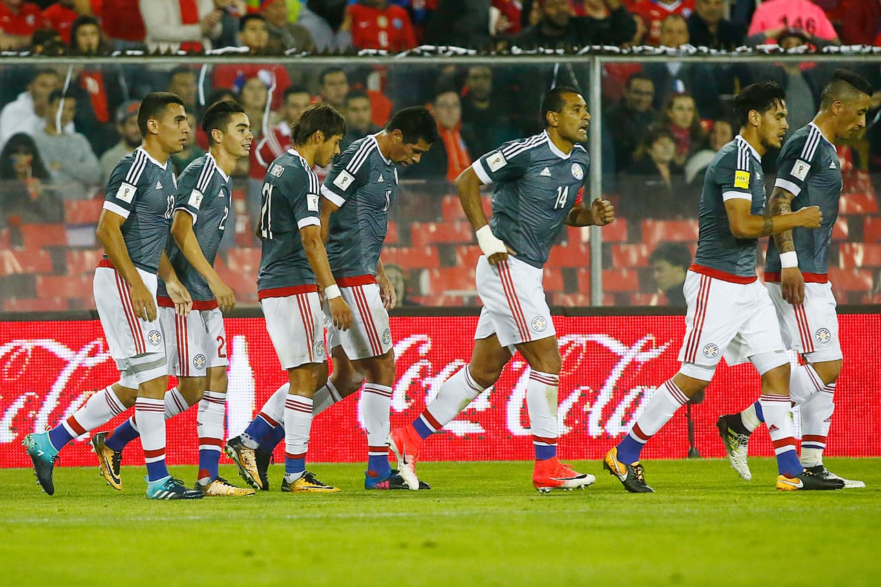 SANTIAGO, CHILE - AUGUST 31: Players of Paraguay celebrate after Arturo Vidal of Chile (not in frame) scored an own goal during a match between Chile and Paraguay as a part of FIFA 2018 World Cup Qualifier at Monumental Stadium on August 31, 2017, in Santiago, Chile. (Photo by Esteban Garay/Getty Images)