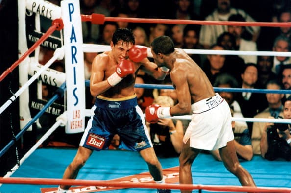 LAS VEGAS - SEPTEMBER 18,1999: Oscar De La Hoya (L) is hit with a right jab from Felix Trinidad during the fight at the Mandalay Bay Resort & Casino,on September 18,1999 in Las Vegas, Nevada. Felix Trinidad won the WBC welterweight title and IBF welterweight title by a MD 12. (Photo by: The Ring Magazine/Getty Images)