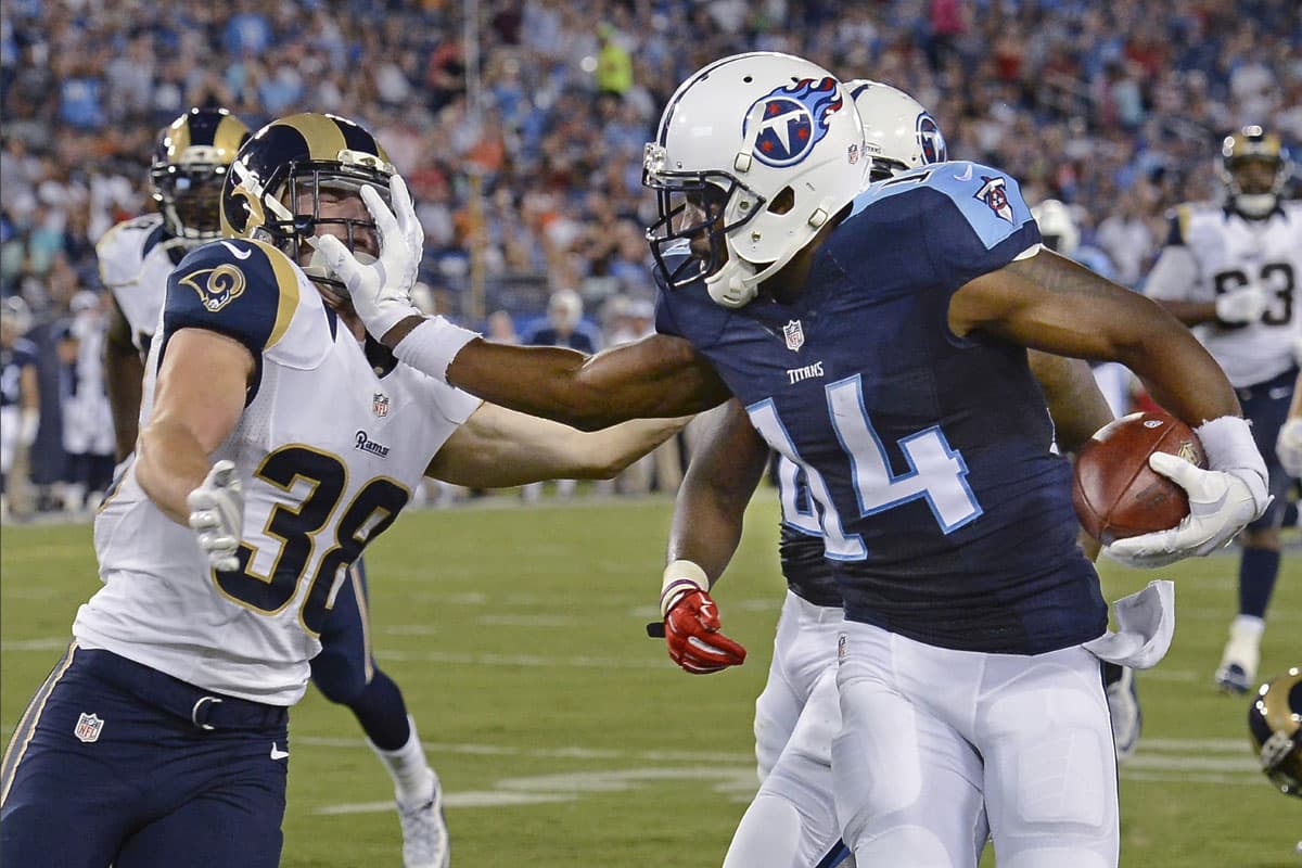 #2. HASTA AQUÍ LLEGASTE: El WR de los Tennessee Titans, Hakeem Nicks (14), alejó con la mano al back defensivo de los St. Louis Rams, Cody Davis (38)